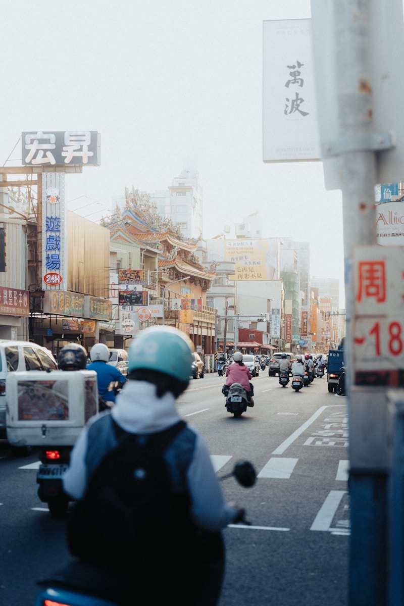 a group of people riding motorcycles down a street