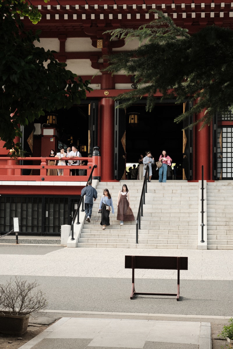 a woman sitting on a bench in front of a building