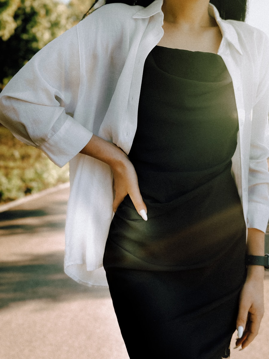 a woman in a black dress and a white jacket