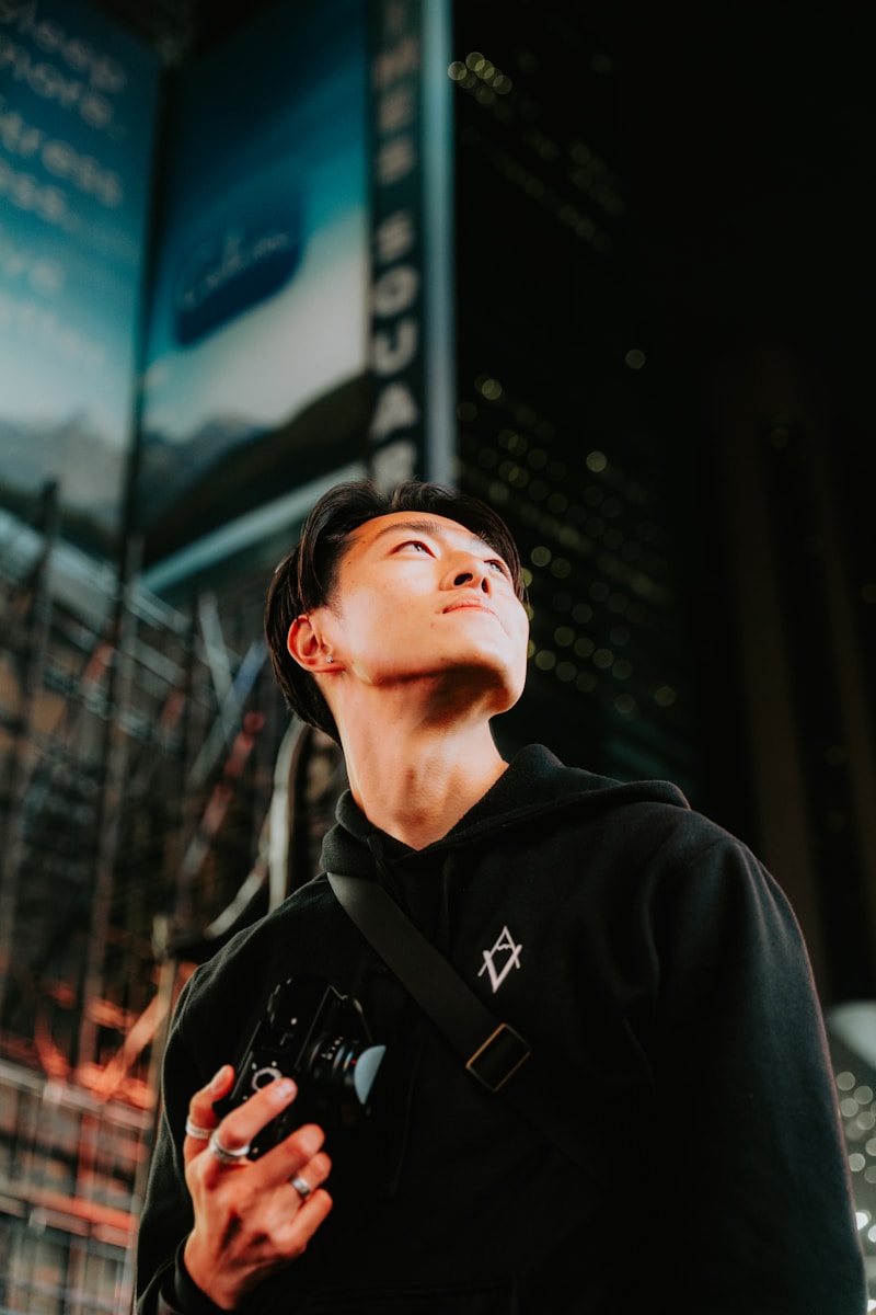 a man standing in front of a tall building