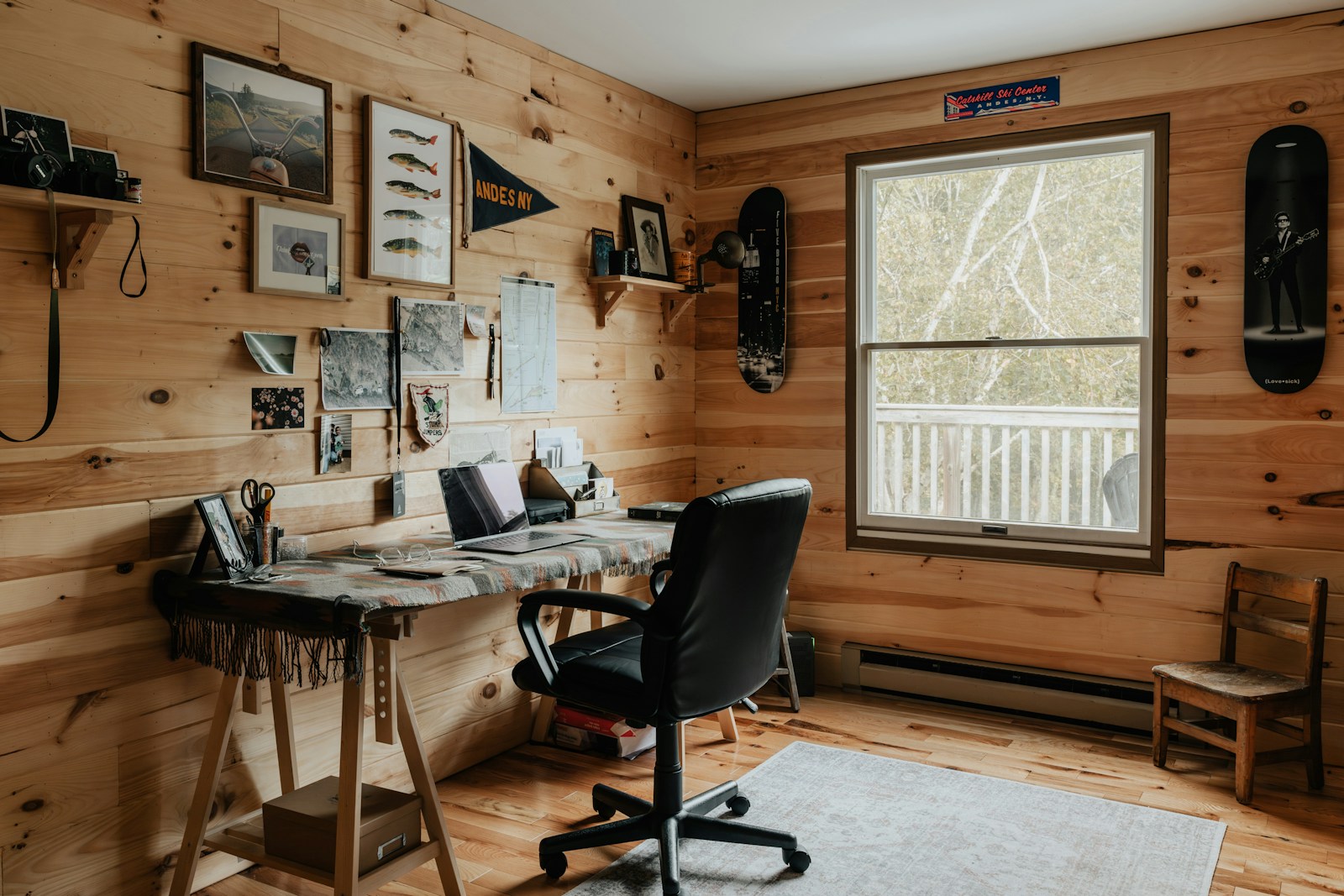 A room with wood paneling and a desk and chair